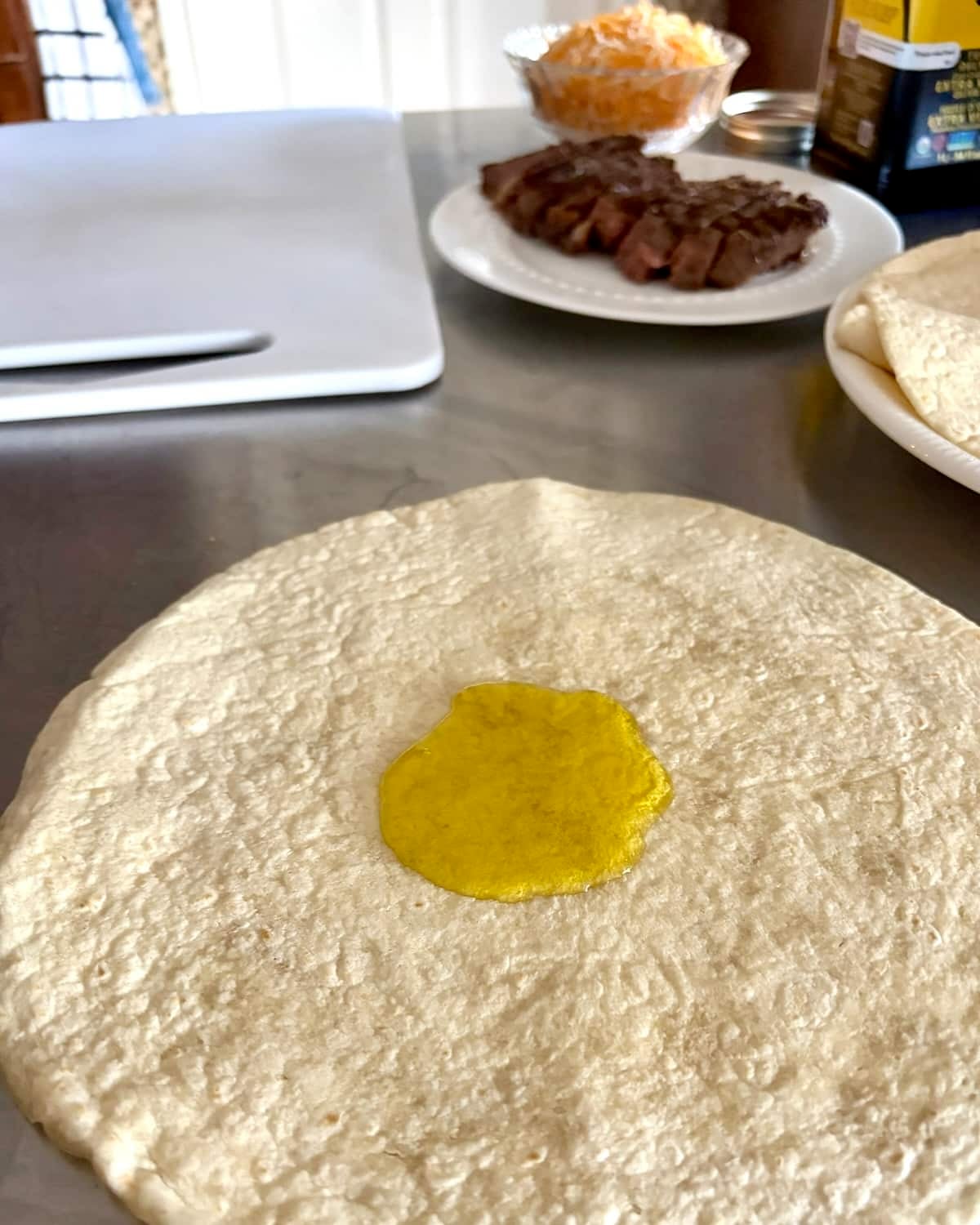 Adding oil to the tortilla.