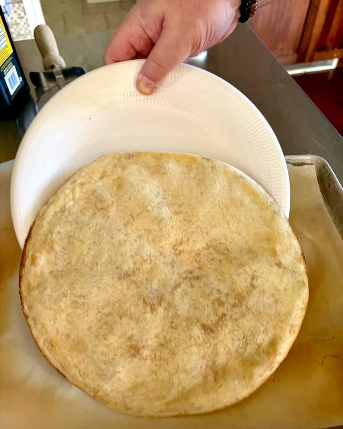 Flip the quesadilla onto a plate to turn it over. Slide back onto the baking sheet.