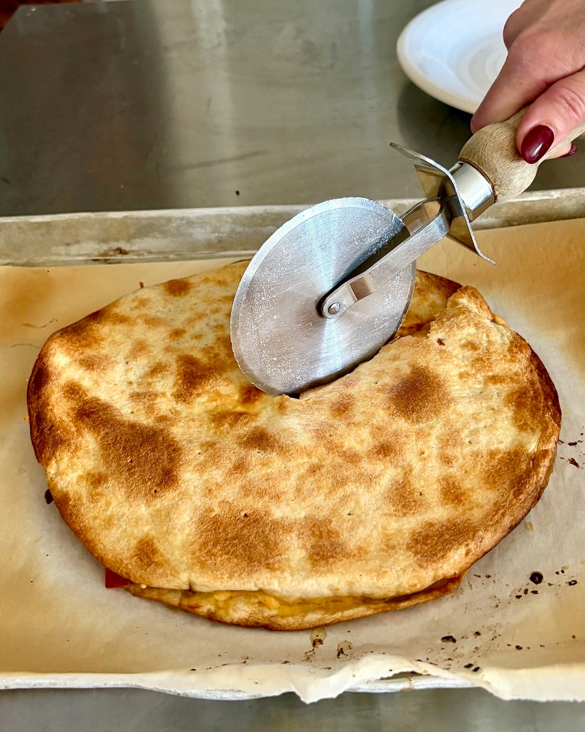 slicing the quesadilla with a pizza cutter.