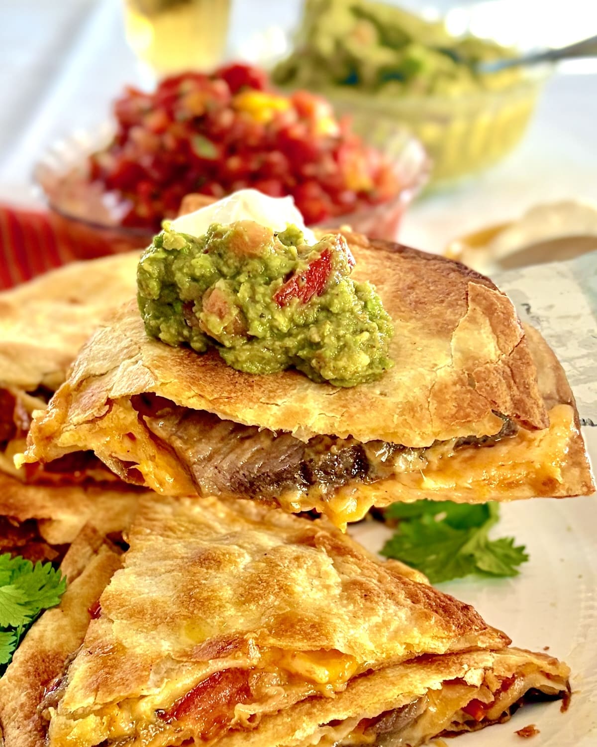 close up ohoto of No Fry Oven Quesadillas. with guacamole and sour cream.