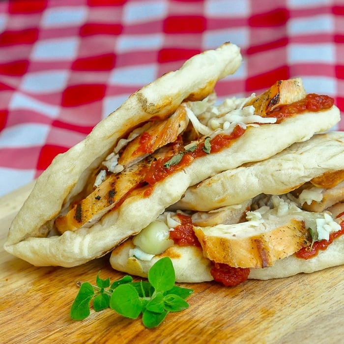Grilled Chicken Parmesan Flatbread Sandwiches close up photo on wooden cutting board
