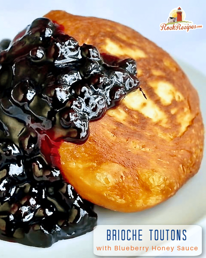Brioche Toutons with Blueberry Honey Sauce photo of one serving on a white plate.with title text added for social media posts.