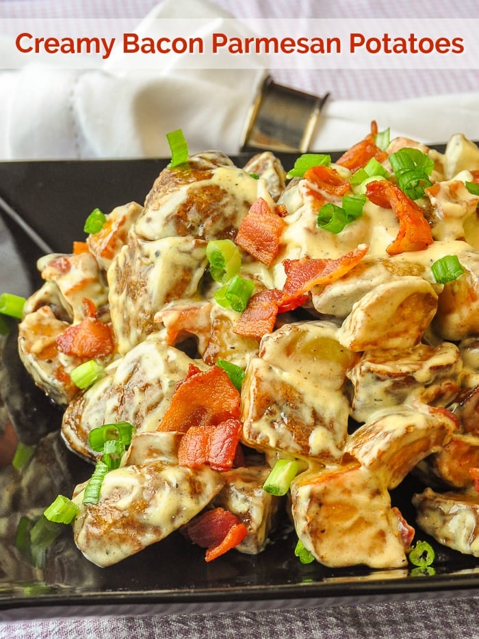 Creamy Bacon Parmesan Potatoes wide shot photo on black serving platter