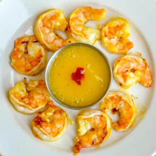 Spicy Orange Mango Grilled Shrimp close up photo on white serving plate
