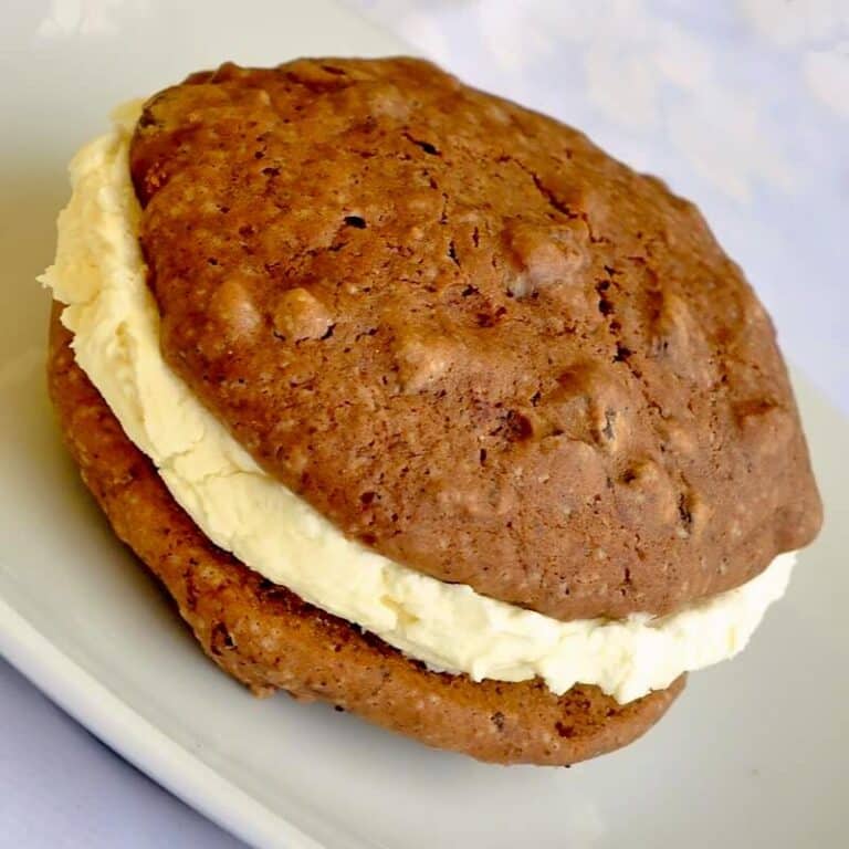 Chocolate Chip Vanilla Cream Whoopie Pies featured image of one serving on a white plate