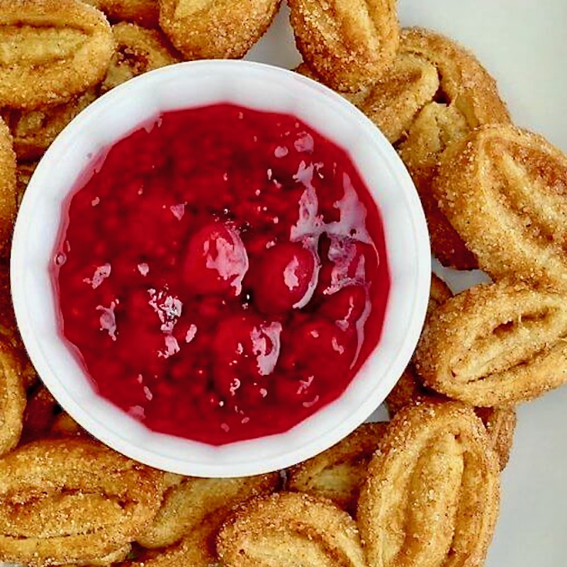 Close up photo of Raspberry Compote in a white ramekin.