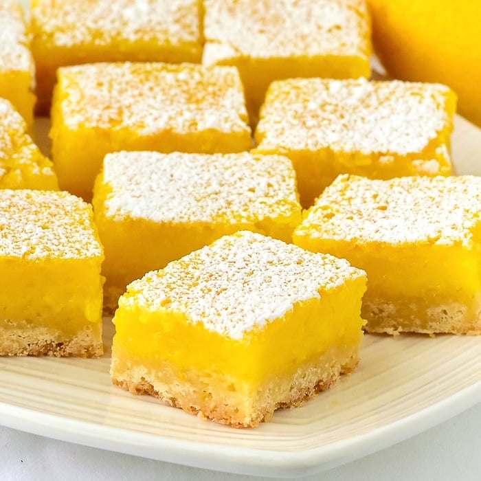 Close up photo of a platter of Super Easy Lemon Bars