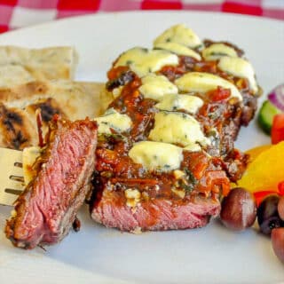 Blue Cheese Steak Puttanesca cut to show medium rare inside