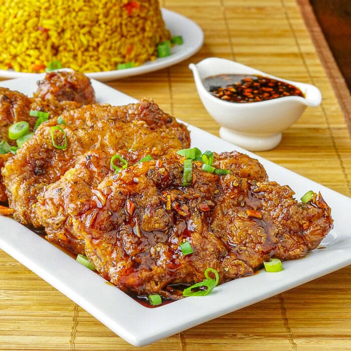 Double Crunch Honey Garlic Pork Chops on a white serving platter.