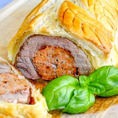 Sausage Pork Tenderloin Wellington close up photo of sliced wellington for featured image