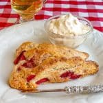Strawberry Shortcake Scones shown on white plate with clotted cream