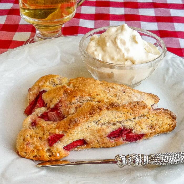 Strawberry Shortcake Scones shown on white plate with clotted cream