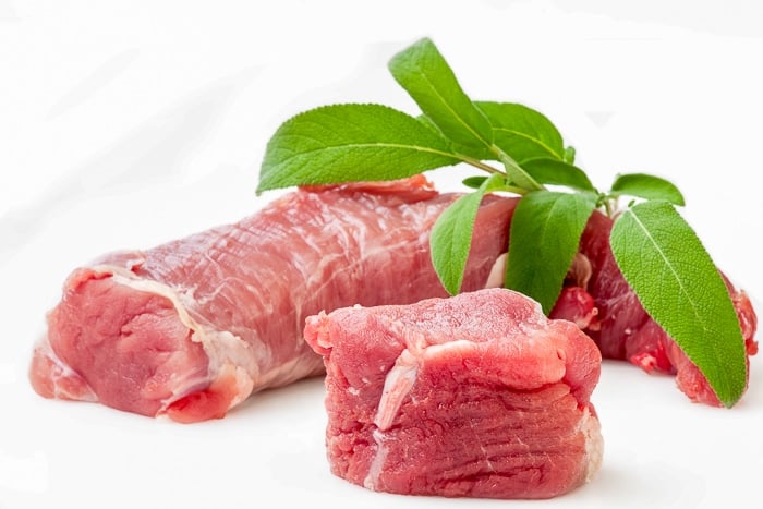 A market fresh raw pork tenderloin with Sage Isolated on White