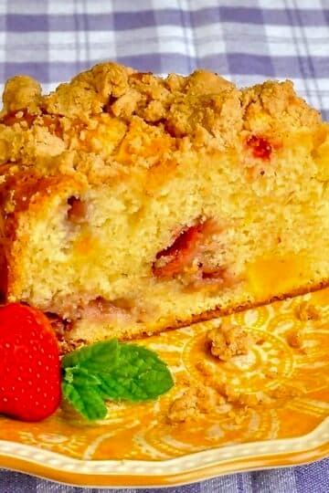 Strawberry Mango Crumb Cake close up photo of single slice on a yellow patterned plate