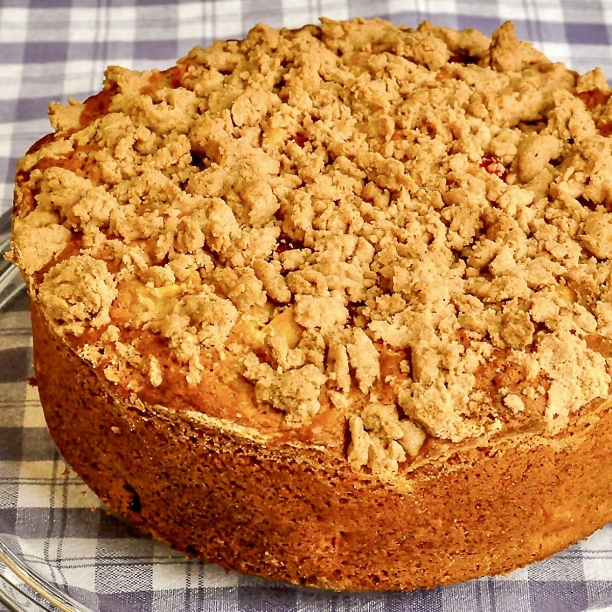 Strawberry Mango Crumb Cake close up shot of cake on glass serving platter.