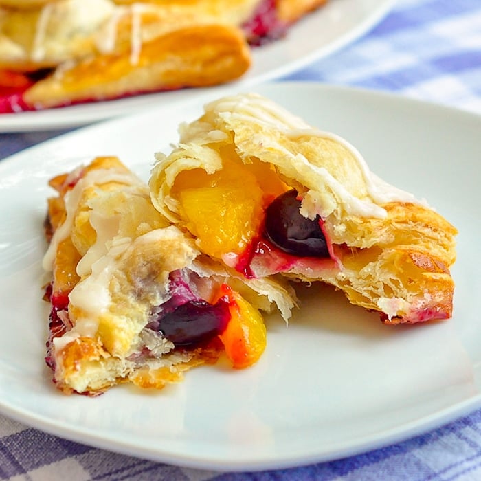 Easy Cherry Peach Turnovers close up photo of one turnover broken open to show filling