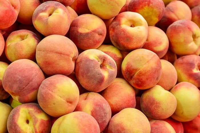 close up of peaches on market stand. Stock Photo