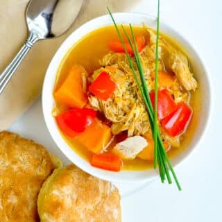 Turkey Quinoa Sweet Potato Soup shown with buttermilk biscuits on the side