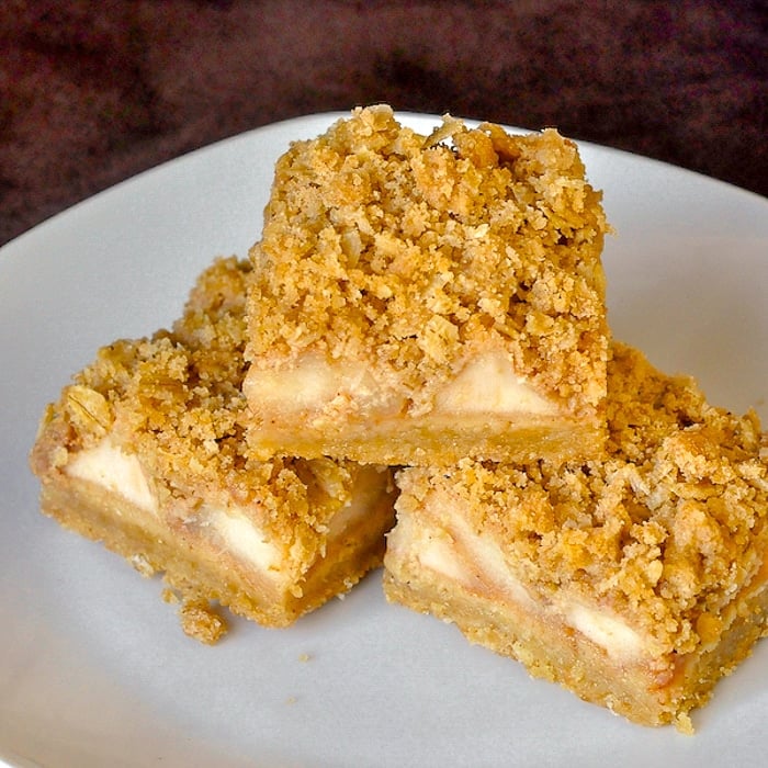 Apple Pie Crumble Bars close up image of 3 cookies on white plate