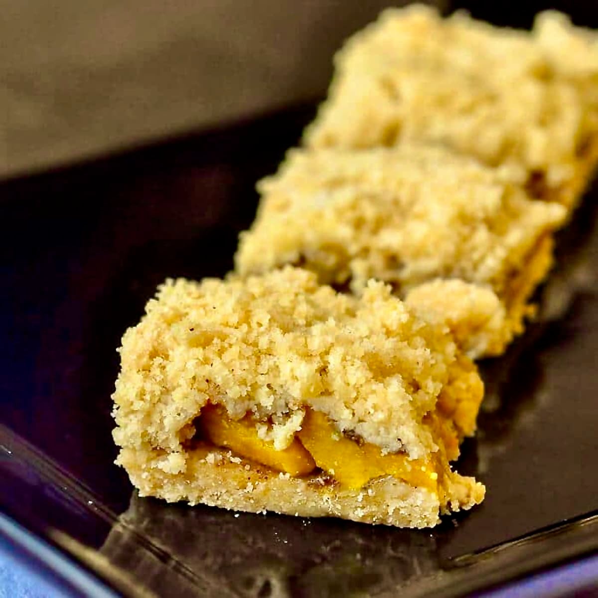 Mango Five Spice Crumble Bars photo of 3 cookie bars in a black serving platter.