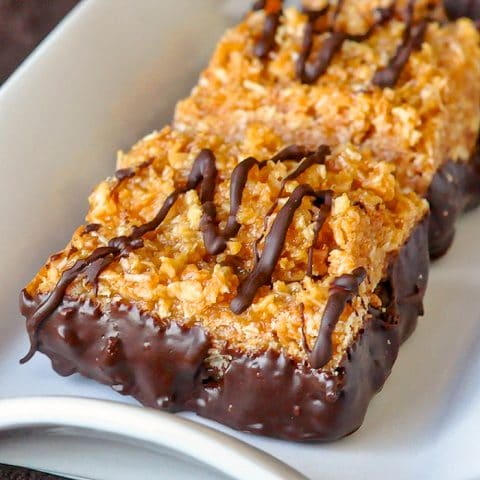 Easy Samoa Bars close up image of a single cookie bar on a white plate