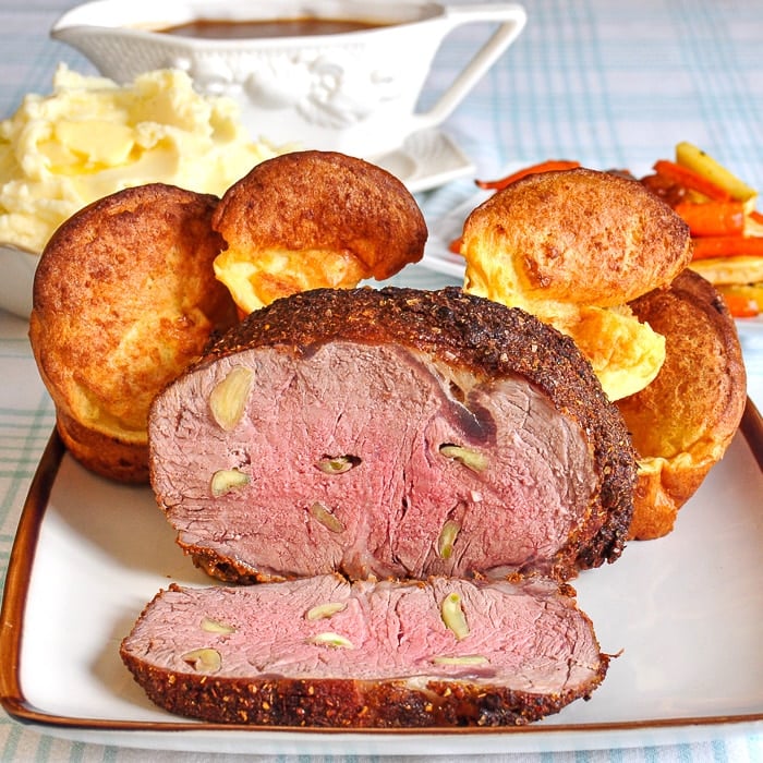 Garlic prime rib sliced open to reveal medium rare interior