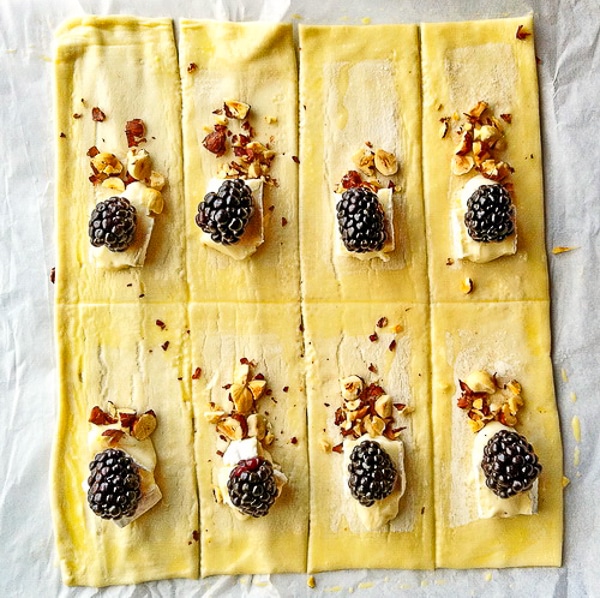 Hazelnut Blackberry Brie Puffs assemb;y shown using a sheet of frozen puff pastry.