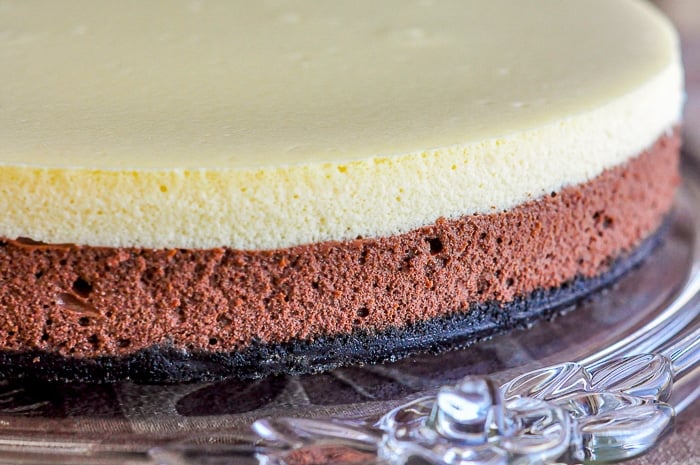 Black and White Cheesecake on a clear glass serving platter