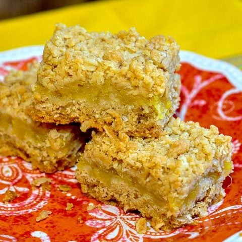 Pineapple Oat Bars photo of 3 cookie squares on an orange plate.