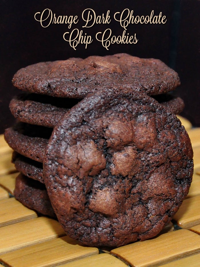 Orange Dark Chocolate Chip Cookies stacked on a bamboo serving plate with title text added for Pinterest