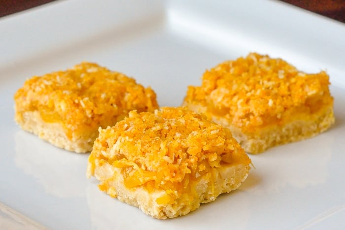 Orange Pineapple Crumble Bars on a white plate