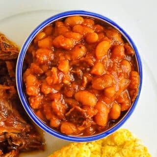 Close up photo of Maple Chipotle Baked Beans in a white ramekin with blue accent