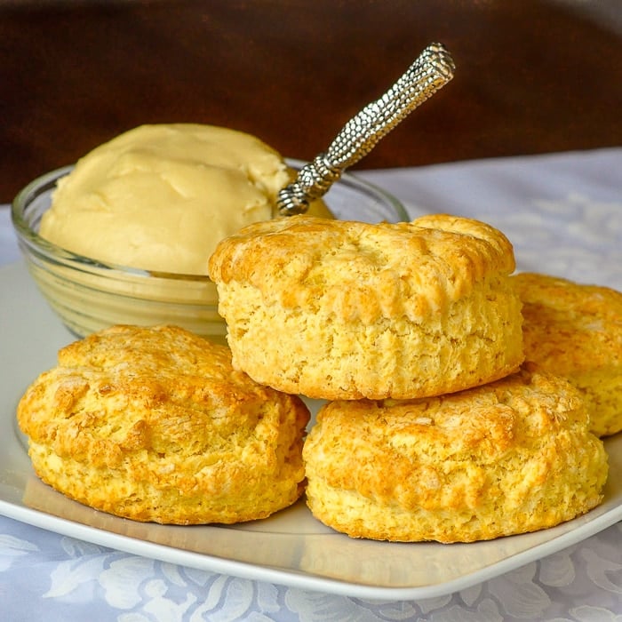 Corn Flour Biscuits on a white plate with maple butter in the background