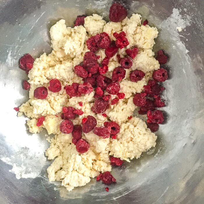 Photo shows when to add the berries to the dough for Raspberry White Chocolate Scones