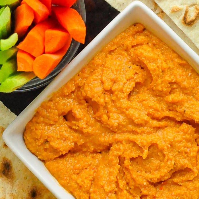 Roasted Red Pepper Hummus close up photo of hummus in a white bowl