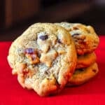 Walnut Chocolate Chip Cookies stacked on red napkin.