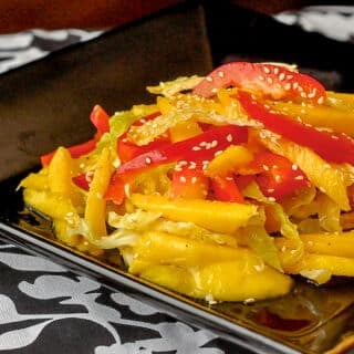 Mango Sesame Coleslaw shown on black serving plate