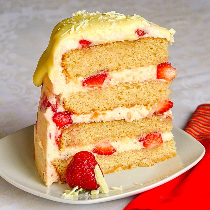 Strawberry White Chocolate Buttercream Cake photo of a single slice of cake on a white plate