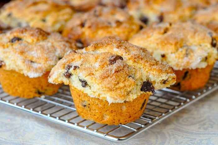 The Best Choc0late Chip Muffins wide shot of muffins cooling on wire rack