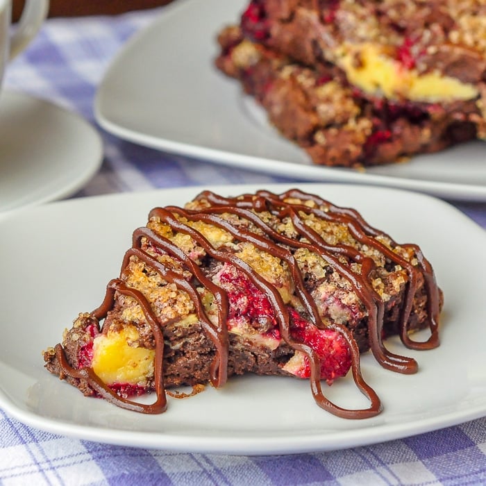 Chocolate Raspberry Cheesecake Scones close up of single scone on a white plate