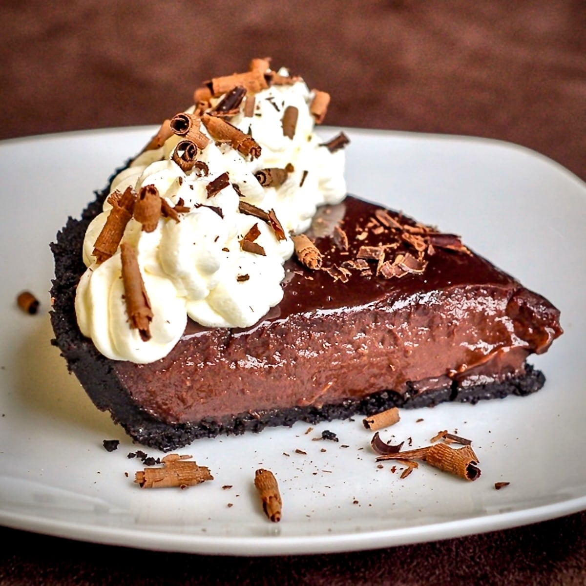 Chocolate Pudding Pie photo of a single slice on a white plate.