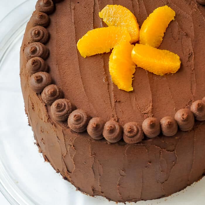 Orange Cake with Easy Chocolate Truffle Frosting - a butter based, old fashioned scratch cake, filled with layers of easy, melt in your mouth chocolate truffle frosting.