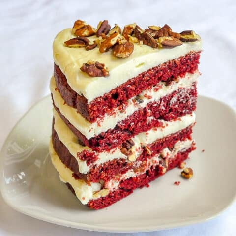 One slice of red velvet cake on a white plate
