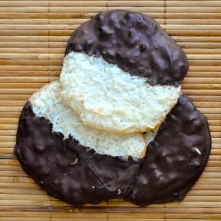 Auntie Craes Chocolate Macaroons square cropped featured image of 3 cookies on a bamboo background.