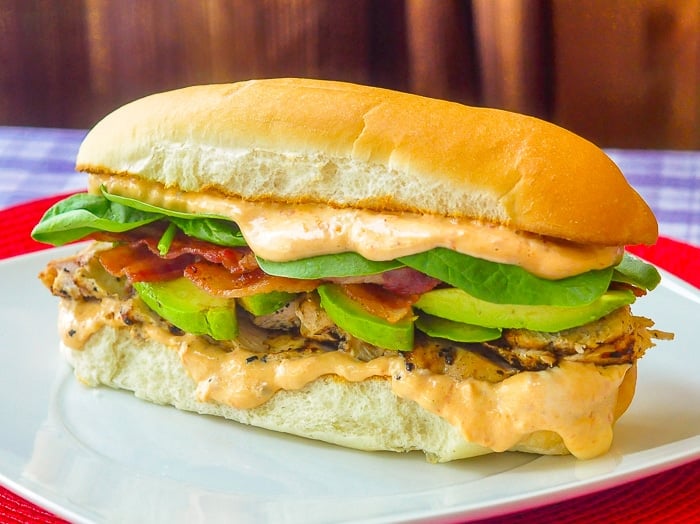 Chicken Avocado Club Sub wide shot on white plate