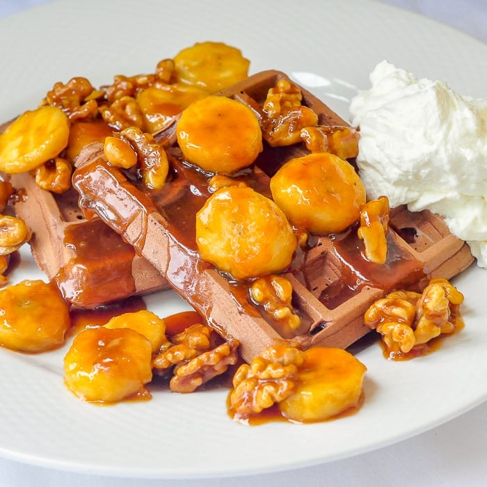 Chocolate Caramel Walnut Banana Waffles close up image on white plate