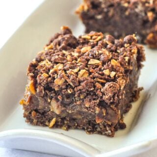 Chocolate Orange Date Crumbles close up photo of one cookie square on a white platter