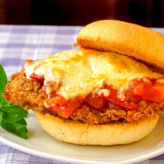Double Crunch Fried Chicken Parmesan Burgers close up photo on a white plate