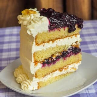 Lemon Blueberry Cream Cake photo of a single slice on a white plate