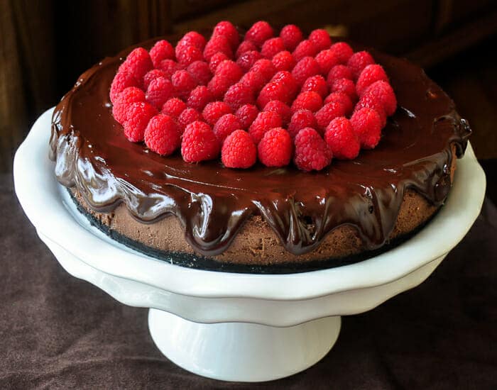 Chocolate Mousse Cheesecake. Photo of entire cheesecake on a pedestal stand.